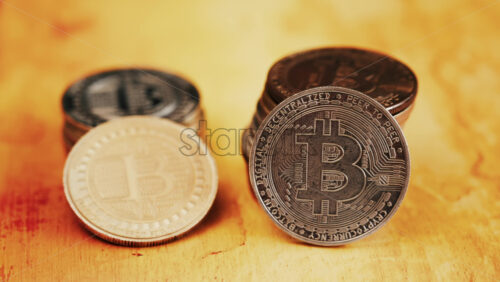 Close up of shiny physical Bitcoin coins stacked on a table - Starpik Stock