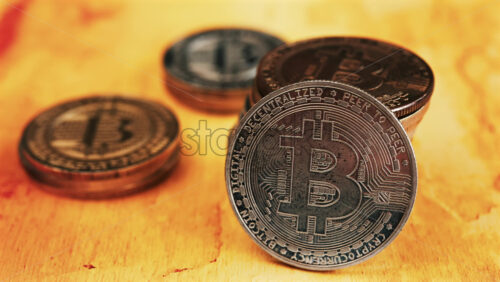 Close up of shiny physical Bitcoin coins stacked on a table - Starpik Stock