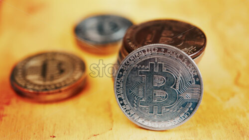 Close up of shiny physical Bitcoin coins stacked on a table - Starpik Stock