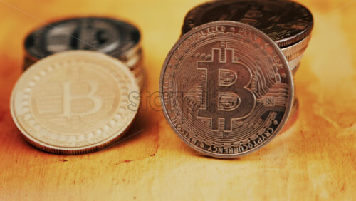 Close up of shiny physical Bitcoin coins stacked on a table - Starpik Stock