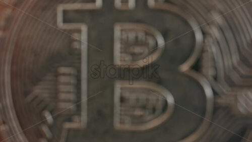 Close up of shiny physical Bitcoin coins stacked on a table - Starpik Stock