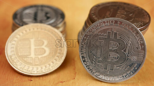 Close up of shiny physical Bitcoin coins stacked on a table - Starpik Stock