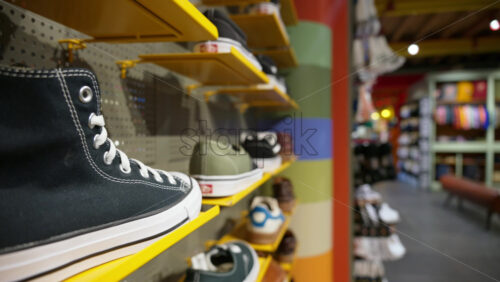 Close up of shoes displayed on shelves at a clothing store - Starpik Stock