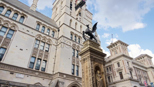 Close up of the Temple Bar dragon statue and intricate Gothic architecture of the Royal Courts of Justice, London, England - Starpik Stock