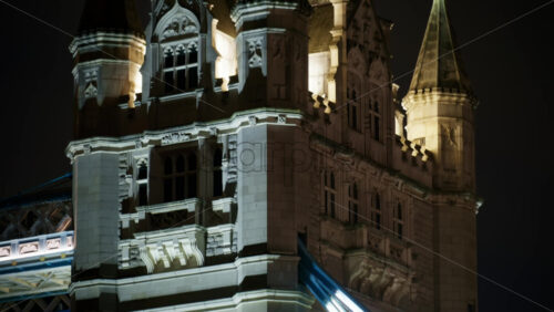 Close-up of the Tower Bridge with light trails from traffic at night in London, England - Starpik Stock