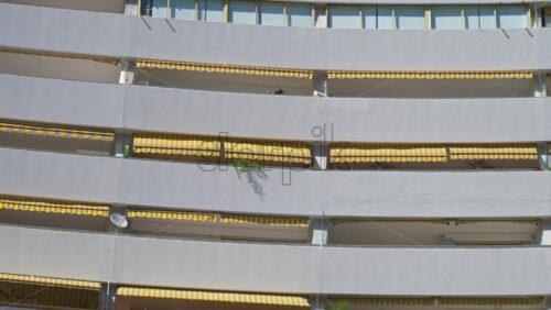 Close up of the windows at the white, large, pyramid-shaped building in the Marina Baie des Anges complex in Villeneuve-Loubet, France - Starpik Stock