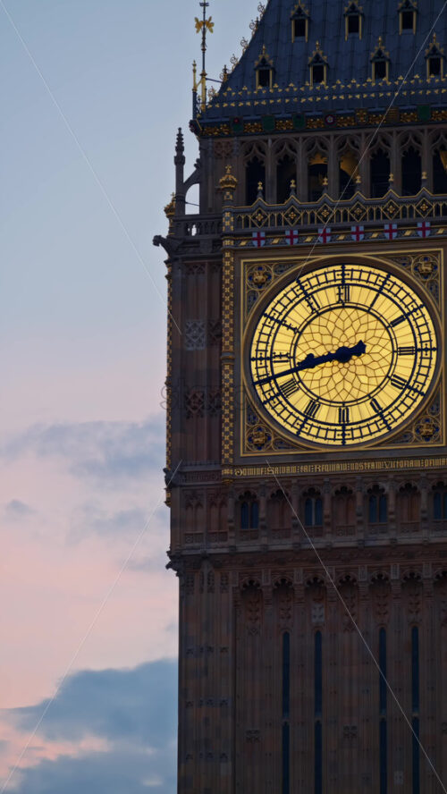 Close-up view of Big Ben illuminated at dusk in London, England. Vertical - Starpik Stock