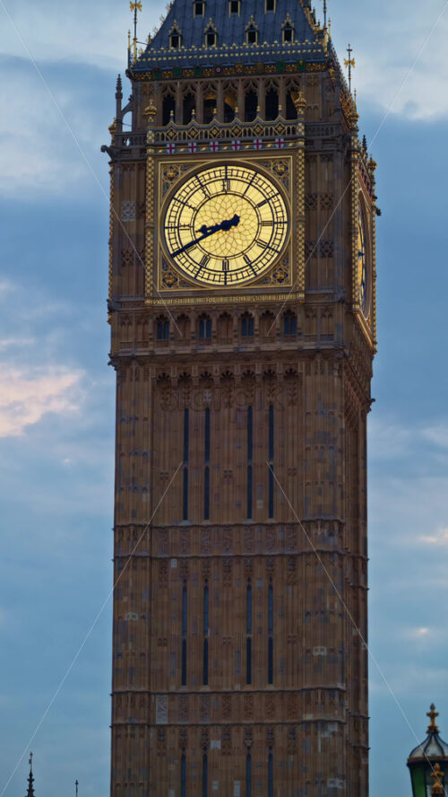 Close-up view of Big Ben illuminated at dusk in London, England. Vertical - Starpik Stock
