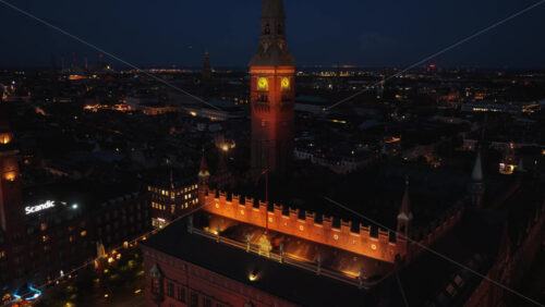 Copenhagen, Denmark – August 3, 2025: Aerial drone view of Copenhagen’s City Hall Square, with glowing lights, historic architecture, and bustling streets - Starpik Stock