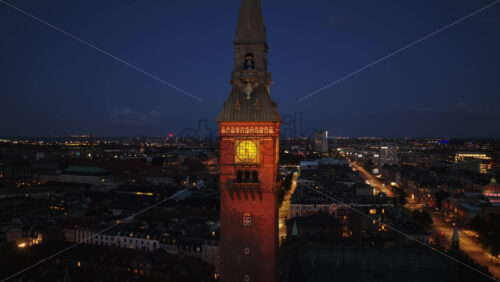 Copenhagen, Denmark – August 3, 2025: Aerial drone view of Copenhagen’s City Hall Square, with glowing lights, historic architecture, and bustling streets - Starpik Stock