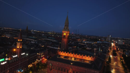 Copenhagen, Denmark – August 3, 2025: Aerial drone view of Copenhagen’s City Hall Square, with glowing lights, historic architecture, and bustling streets - Starpik Stock