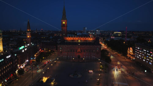 Copenhagen, Denmark – August 3, 2025: Aerial drone view of Copenhagen’s City Hall Square, with glowing lights, historic architecture, and bustling streets - Starpik Stock