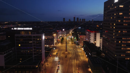 Copenhagen, Denmark – August 3, 2025: Aerial drone view of Vesterbrogade street at night near Tivoli Gardens - Starpik Stock