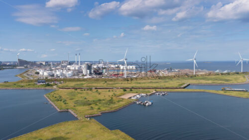 Copenhagen, Denmark – August 4, 2025: Aerial drone view of Amager Strandpark beaches and promenade with Middelgrunden wind turbines lined across the horizon - Starpik Stock