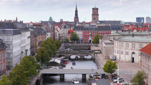 Copenhagen, Denmark – August 4, 2025: Aerial drone view of Frederiksholms Kanal and Slotsholmen in Copenhagen, with historic buildings and colorful rooftops - Starpik Stock