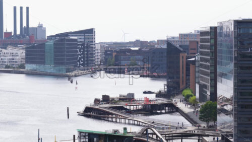 Copenhagen, Denmark – August 4, 2025: Aerial drone view of Langebro Bridge with its green copper tower and views of Kalvebod Brygge promenade in daylight - Starpik Stock