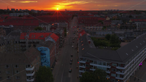 Copenhagen, Denmark – August 4, 2025: Aerial drone view of Norrebrogade, one of the busiest streets in Norrebro, looking towards the city center skyline at sunset - Starpik Stock