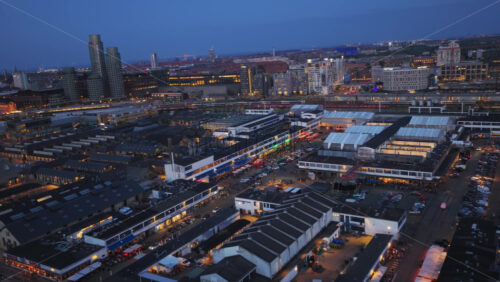 Copenhagen, Denmark – August 4, 2025: Aerial drone view of Reffen Street Food Market and industrial harbor area at night - Starpik Stock