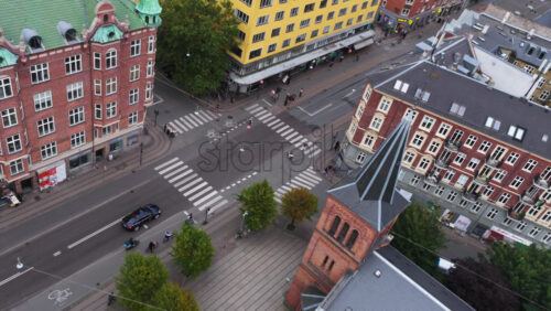 Copenhagen, Denmark – August 4, 2025: Aerial drone view of a small red-brick church in Norrebro, surrounded by residential blocks with distinctive architecture - Starpik Stock