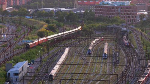 Copenhagen, Denmark – August 4, 2025: Aerial drone view of intercity trains and S-trains in the rail yard near Copenhagen Central Station - Starpik Stock
