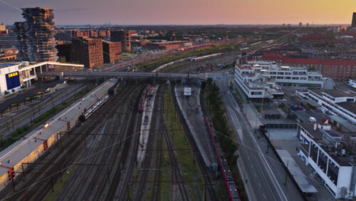 Copenhagen, Denmark – August 4, 2025: Aerial drone view of railway lines near Fisketorvet and Kalvebod Brygge, with hotels and modern office buildings - Starpik Stock