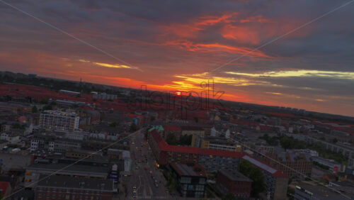 Copenhagen, Denmark – August 4, 2025: Aerial drone view of the harbor area near Reffen street food market and Nordhavn district, lit up with colorful lights and modern architecture - Starpik Stock