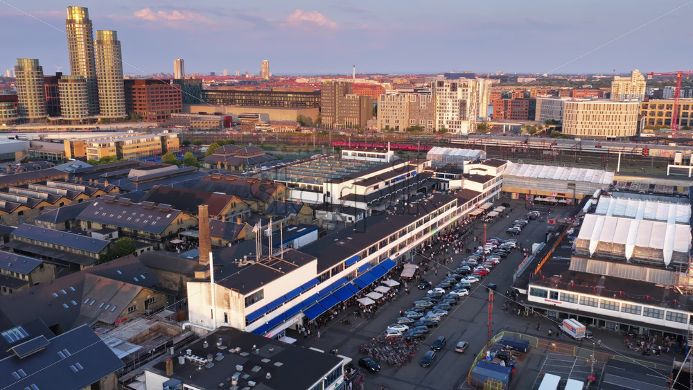 Copenhagen, Denmark – August 4, 2025: Aerial drone view over the lively Reffen street food and cultural market area with warehouses, crowds, and waterfront vibes - Starpik Stock