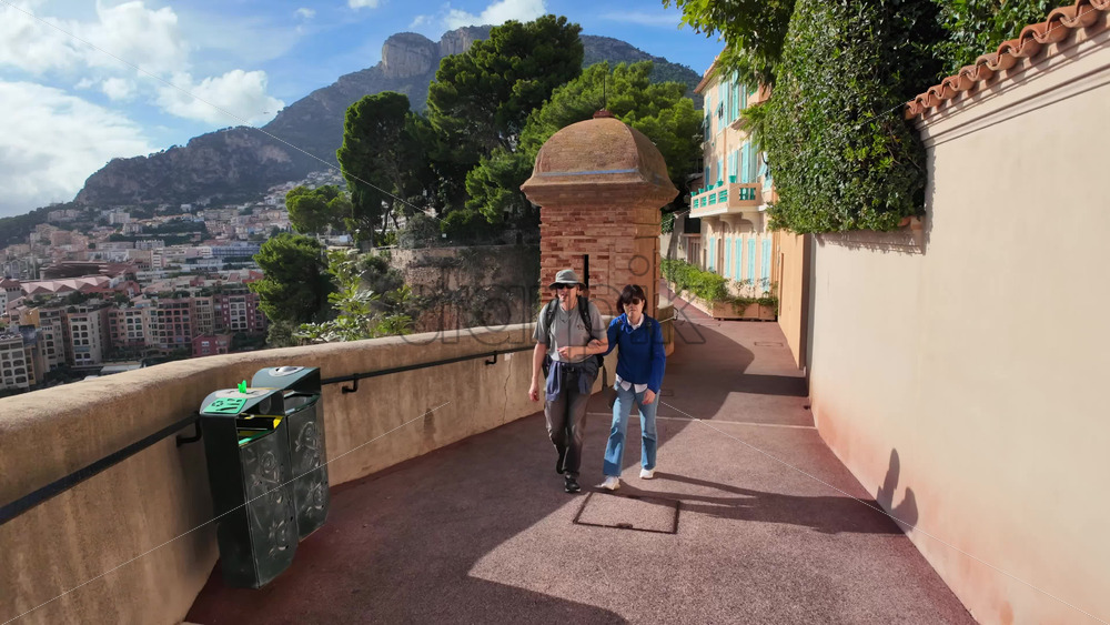 High-angle view of Port de Fontvieille in Monaco, showcasing colorful buildings, luxury yachts, and the surrounding mountainous landscape - Starpik Stock