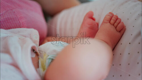 Intimate close up of a mother breastfeeding her baby - Starpik Stock
