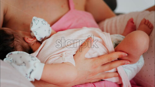 Intimate close up of a mother breastfeeding her baby - Starpik Stock