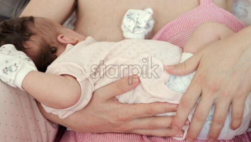 Intimate close up of a mother breastfeeding her baby - Starpik Stock