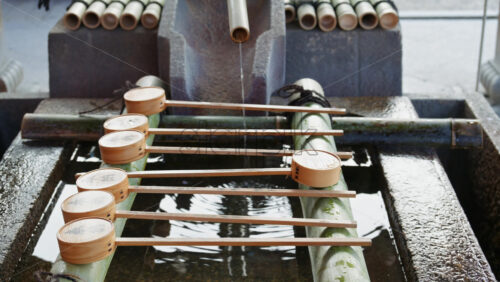 Kyoto, Japan – April 11, 2025: Close up of a purification water fountain at the Yasaka shrine in daylight in Kyoto, Japan - Starpik Stock