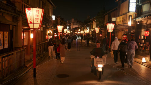 Kyoto, Japan – April 11, 2025: People walking on the streets of the Gion area in the evening. Translation: “Laurel wreath” - Starpik Stock
