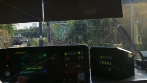 Kyoto, Japan – April 11, 2025: View from a moving train window of another train moving on the rails in Tokyo, Japan - Starpik Stock
