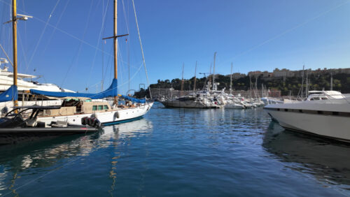La Condamine, Monaco – July 18, 2025: Luxury yachts and sailing boats docked in calm blue waters at the marina - Starpik Stock