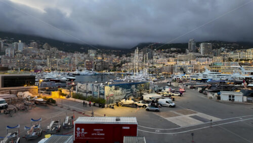 La Condamine, Monaco – July 18, 2025: Packed harbour of yachts against dense hillside apartments under grey clouds - Starpik Stock