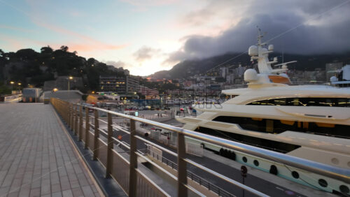 La Condamine, Monaco – July 18, 2025: Packed harbour of yachts against dense hillside apartments under grey clouds - Starpik Stock