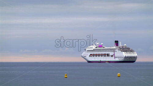 La Condamine, Monaco – July 4, 2025: A white cruise ship floating on calm water with navigation buoys in front - Starpik Stock