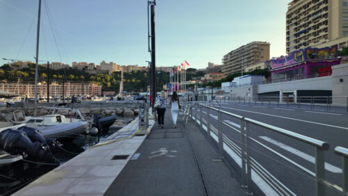 La Condamine, Monaco – July 8, 2025: Boats docked in Port Hercule with buildings on the background in the evening - Starpik Stock