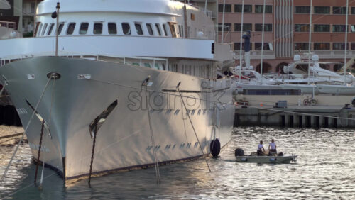 La Condamine, Monaco – July 8, 2025: Boats docked in Port Hercule with buildings on the background in the evening - Starpik Stock