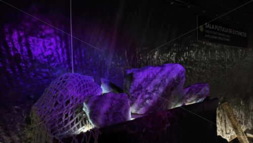 Large salt rocks displayed under colourful lighting at Turda Salt Mine in Turda, Romania - Starpik Stock
