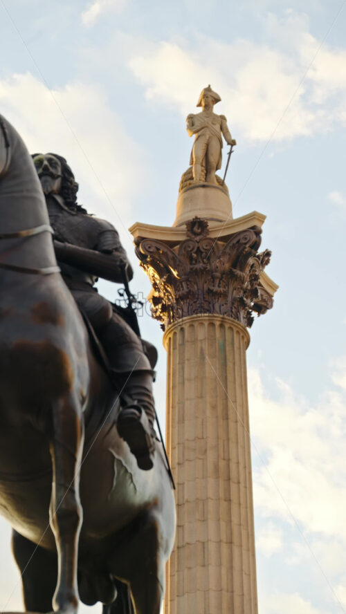 London, England – May 11, 2025: Close-up view of an the towering column of Nelson’s Column in Trafalgar Square, with blue skies and scattered clouds in the background. Vertical - Starpik Stock