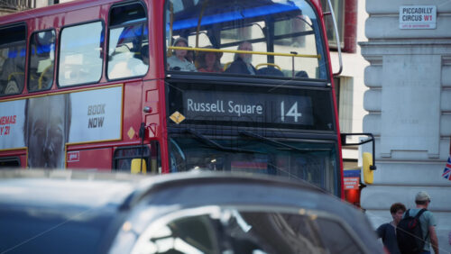 London, England – May 11, 2025: Red double-decker bus heading to Russell Square during evening traffic - Starpik Stock