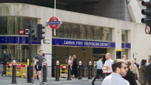 London, England – May 12, 2025: Busy street view outside Cannon Street Underground Station during daytime with people commuting - Starpik Stock