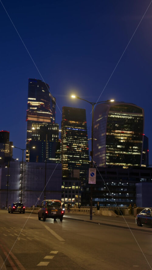 London, England – May 12, 2025: Cityscape view showing modern skyscrapers, including the Walkie Talkie building, and the London Bridge. Vertical - Starpik Stock