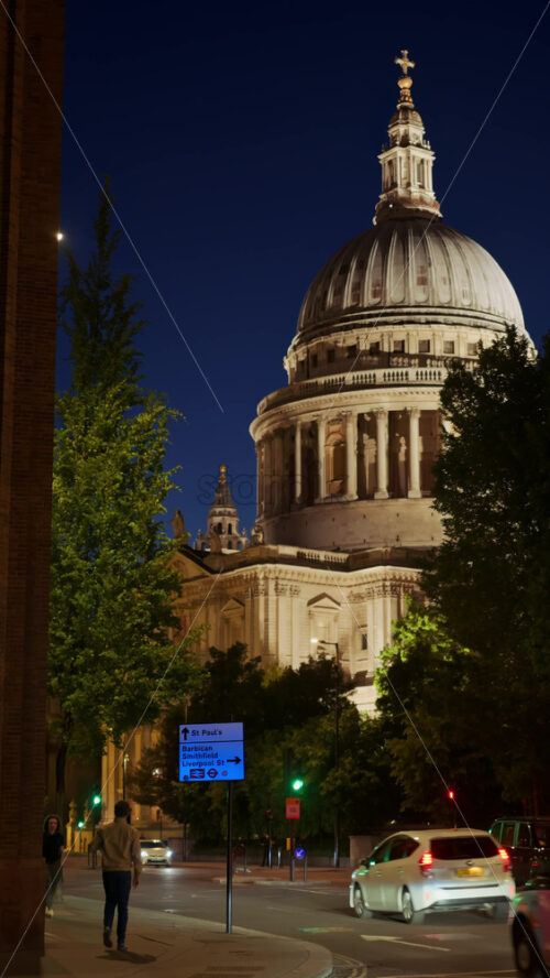 London, England – May 12, 2025: View of St. Paul’s Cathedral with cars moving along a busy street at night. Vertical - Starpik Stock