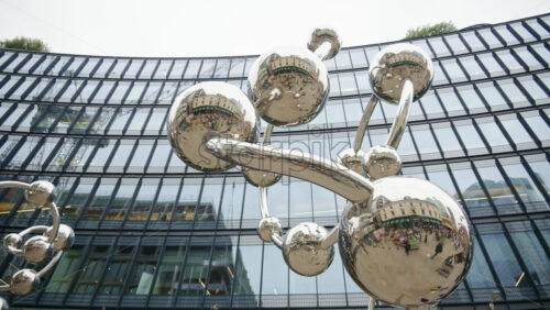 London, England – May 14, 2025: Reflective metallic spheres The Bubble Bond located in the plaza outside a modern office building in London’s financial district near Liverpool station - Starpik Stock