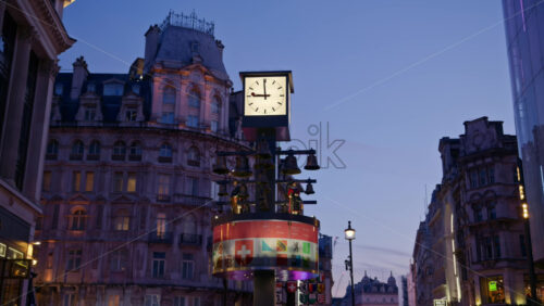 London, England – May 14, 2025: Swiss Glockenspiel clock in the evening at blue hour - Starpik Stock