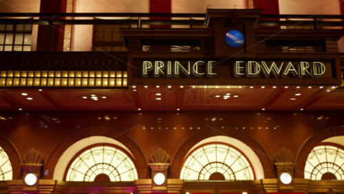London, England – May 14, 2025: The entrance to the Prince Edward Theatre illuminated in the heart of the city at night in Soho - Starpik Stock