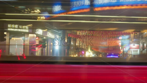 London, England – May 14, 2025: Time lapse of people and cars moving through China Town under red paper lanterns in the evening - Starpik Stock
